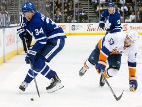 Toronto Maple Leafs' Auston Matthews takes the puck away from New York Islanders' Casey Cizikas during NHL action on Feb. 22, 2018