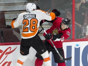 Senators defenceman Fredrik Claesson collides with Philadelphia Flyers' Claude Giroux during Saturday's game. (THE CANADIAN PRESS)