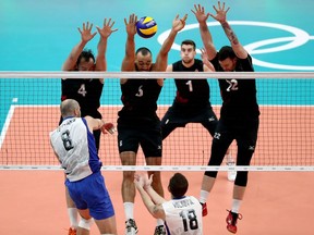 Canadian blockers try to form a wall against an attack by Russia during a quarterfinal of the Rio Olympic tournament in 2016.