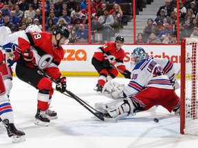 Derick Brassard of the Ottawa Senators tips the puck past Henrik Lundqvist of the New York Rangers as Mark Borowiecki looks on in the second period at the Canadian Tire Centre on Saturday, Feb. 17, 2018.