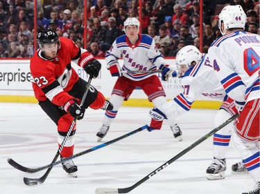 Nick Shore of the Ottawa Senators shoots the puck as Jesper Fast of the New York Rangers makes a stick check in the second period.