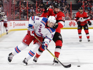 Zack Smith of the Ottawa Senators battles for position against Brady Skjei.