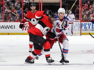 Senators defencmean Johnny Oduya battles for position against Brady Skjei of the Rangers in the third period.