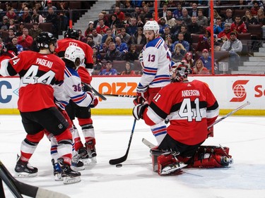 Craig Anderson of the Senators makes a save as Kevin Hayes of the Rangers looks for a tip and Jean-Gabriel Pageau (44) and Cody Ceci (5) defend against Mats Zuccarello in the third period.