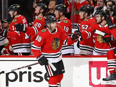 Patrick Kane of the Chicago Blackhawks is congratulated by teammates after scoring in the first.