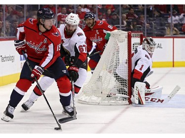 WASHINGTON, DC - FEBRUARY 27: Nicklas Backstrom #19 of the Washington Capitals skates with the puck past Ben Harpur #67 of the Ottawa Senators during the second period at Capital One Arena on February 27, 2018 in Washington, DC.