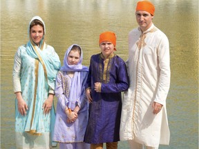 Canada's Prime Minister Justin Trudeau (R), along with his wife Sophie Gregoire Trudeau (L), daughter Ella-Grace (2nd L) and son Xavier (2nd R) pose for a family photo as they pay their respects at the Sikh Golden Temple in Amritsar on February 21, 2018. Trudeau and his family are on a week-long official trip to India.