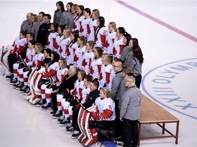 Members of the Canadian women's hockey team pose for a photo during a practice on Thursday.