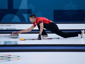 John Morris throws a stone during Canada's mixed doubles round-robin game against Switzerland on Saturday.