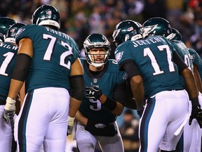 Quarterback Nick Foles of the Philadelphia Eagles and teammates Aziz Shittu, Halapoulivaati Vaitai and Alshon Jeffery huddle during the NFC Divisional Playoff game at Lincoln Financial Field on January 13, 2018 in Philadelphia. (Mitchell Leff/Getty Images)