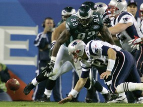 In this Feb. 6, 2005, file photo, New England Patriots quarterback Tom Brady fumbles the ball as Philadelphia Eagles defensive end Jevon Kearse (93) moves in on the play during the second quarter of Super Bowl XXXIX at Alltel Stadium in Jacksonville, Fla. The Eagles recovered the fumble. The two teams meet in a rematch in Super Bowl 52 on Sunday, Feb. 4, 2018, in Minneapolis. (AP Photo/Gene J. Puskar, File)