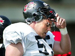 Ottawa Renegades tackle Chris Burns takes a break during practice at Frank Clair Stadium in 2002.