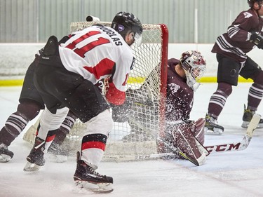 Carleton's Travis Douglas attacks at the side of uOttawa goalie Anthony Brodeur's net.