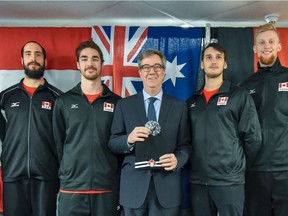 Mayor Jim Watson, middle, joins Volleyball Canada National Training Centre athletes, left to right, Josh Edwards, Gavin Taylor, Eric Girard and James Jackson for the Volleyball Nations League announcement at TD Place arena on Wednesday.  Steve Kingsman/Freestyle Photography