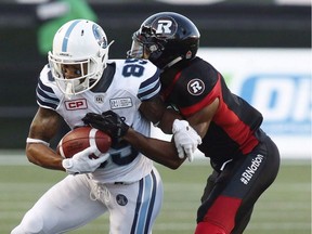 Toronto Argonauts wide receiver DeVier Posey (85) is tackled by the Ottawa Redblacks defensive back Jonathan Rose (9) during the first half of CFL football action in Ottawa on Saturday, July 8, 2017. Redblacks signed American defensive Jonathan Rose to a one-year contract extension Monday.