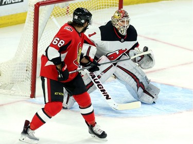 Ottawa Senators Mike Hoffman (68) tries to deflect the puck as New Jersey Devils goaltender Keith Kinkaid(1) reacts during first period NHL action in Ottawa, Tuesday, February 6, 2018 .