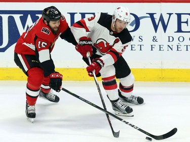 Ottawa Senators Zack Smith (15) battles for the puck with New Jersey Devils Taylor Hall (9)during second period NHL action in Ottawa, Tuesday, February 6, 2018.