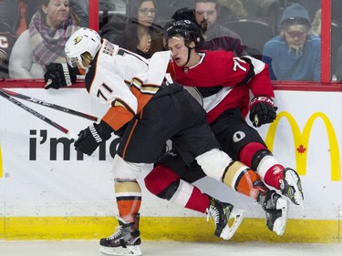 Anaheim Ducks right wing J.T. Brown sends Ottawa Senators defenceman Thomas Chabot into the boards during second period NHL action, Thursday, February 1, 2018 in Ottawa.