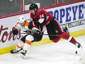 Senators defenceman Mark Borowiecki leans on Flyers defenceman Shayne Gostisbehere during a game in Ottawa on Oct. 26. The Senators won 5-4.