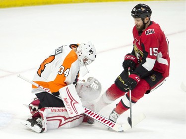 Ottawa Senators left wing Zack Smith pressures Philadelphia Flyers goaltender Petr Mrazek as he tries to control a shot during first period NHL action Saturday February 24, 2018 in Ottawa.