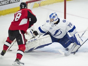 Senators left-winger Ryan Dzingel stickhandles around the pad of Lightning netminder Louis Domingue before scoring to tie the game 1-1 in the first period.