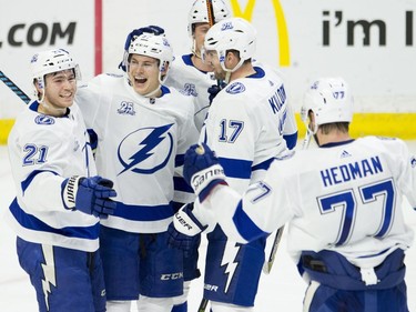 Lightning forward Brayden Point, left, celebrates his second-period goal with teammates Yanni Gourde (37), Alex Killorn (17) and Victor Hedman (77).