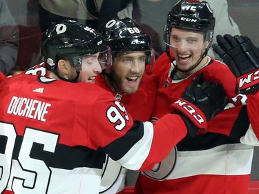 The Senators' Mike Hoffman, centre, celebrates his winning overtime goal with teammates Matt Duchene (95) and Thomas Chabot.