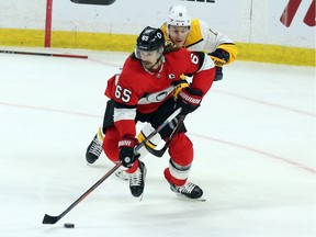 Senators captain Erik Karlsson tries to skate away from Predators forward Kyle Turris during a Feb. 8 game at Canadian Tire Centre.