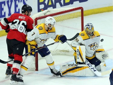 Nashville Predators goaltender Juuse Saros (74) get ready to block a shot as teammate Yannick Weber (7) and Ottawa Senators Colin White (36) look on during first period NHL action in Ottawa, Thursday, February 8, 2018.