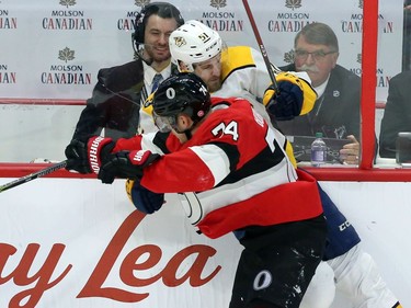 Ottawa Senators Mark Boroweicki (74)checks Nashville Predators Auston Watson (51) during second period NHL action in Ottawa, Thursday, February 8, 2018.