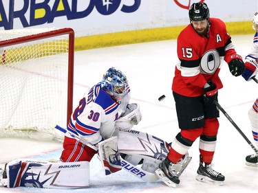 The Ottawa Senators' Zack Smith attempts to screen New York Rangers goaltender Henrik Lundqvist.