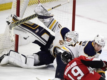 The puck, seen behind the right pad of Buffalo Sabres goaltender Robin Lehner, enters the net on a shot by the Ottawa Senators' Derick Brassard to tie the game in the last minute of the third period.