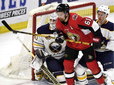 The Senators' Mark Stone tries to deflect the puck in front of Robin Lehner as Casey Nelson looks on.