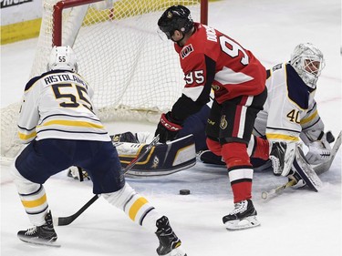 The Senators' Matt Duchene is unable to control the puck in tight against Sabres goaltender Robin Lehner and Rasmus Ristolainen during the first period.