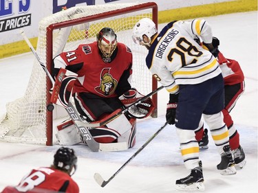 The Buffalo Sabres' Zemgus Girgensons watches as the puck passes the goal post of Ottawa Senators goaltender Craig Anderson in the second period.