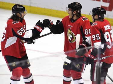The Ottawa Senators' Mike Hoffman celebrates his game-winning goal against the Buffalo Sabres with Erik Karlsson (65) and Matt Duchene (95) during overtime.