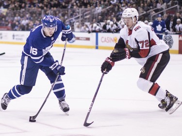 Senators defenceman Thomas Chabot (72) tries to cut off Maple Leafs forward Mitchell Marner as he shoots on goal during second-period action. THE CANADIAN PRESS/Chris Young