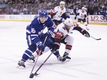 Toronto's Mitchell Marner brings the puck past Ottawa's Johnny Oduya during the second period. THE CANADIAN PRESS/Chris Young