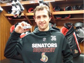Colin White shows off the puck from his first NHL goal with the Senators. The 21-year-old was sent to Belleville of the AHL on Friday, but should be back if, as expected, the Senators deal a veteran forward or two before Feb. 27. Bruce Garrioch/Postmedia
