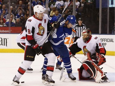 Senators defenceman Dion Phaneuf(2) jousts with Maple Leafs forward Patrick Marleau (12) in front of goalie Craig Anderson during the first period. Jack Boland/Postmedia
