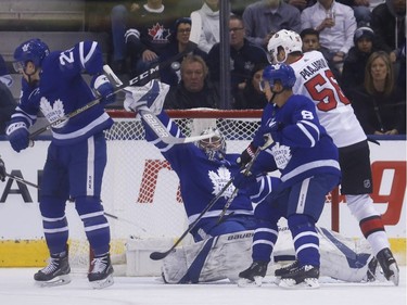 Maple Leafs netminder Frederik Andersen (31) makes an acrobatic save in front of Senators forward Magnus Paajarvi (56) during the first period. Jack Boland/Postmedia