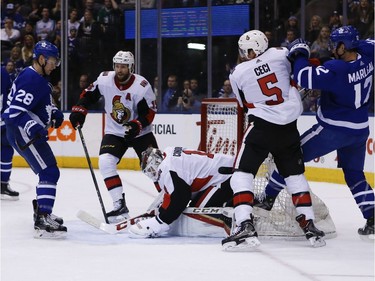 Senators goalie Mike Condon smothers the puck after entering the game in the first period as a replacement for starter Craig Anderson. Jack Boland/Postmedia