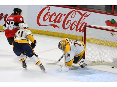 Mike Hoffman scores an overtime goal against Nashville Predators goaltender Juuse Saros to give the Senators a win.