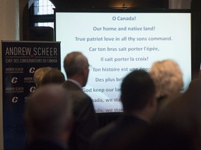 The words to O Canada are projected on a screen during singing of the national anthem at the beginning of the national Conservative caucus in Victoria, B.C., on Jan. 24, 2018.