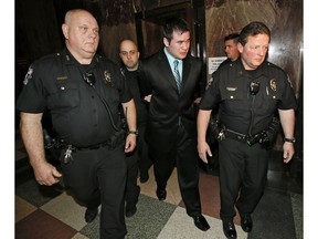 Former Oklahoma City police officer Daniel Holtzclaw, center, cries as he is led from the courtroom after the verdicts were read for the charges against him at the Oklahoma County Courthouse in Oklahoma City, Thursday, Dec. 10, 2015. Holtzclaw was convicted of raping and sexually victimizing eight women on his police beat in a minority, low-income neighborhood.