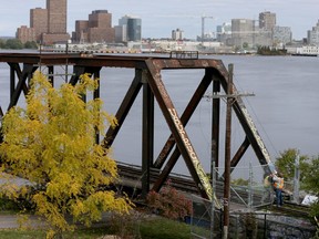 Crews fixed a vandalized wire fence that closes off the Prince of Wales Bridge over the Ottawa River in Ottawa Ontario Friday Oct. 14, 2016.