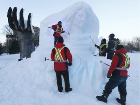 Crews work on the ice sculptures.