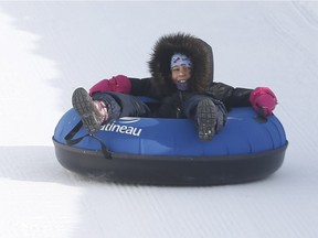 A child tubes down a slide at the opening of the official launch of the 40th Winterlude in Gatineau Quebec Friday Feb 2, 2018.