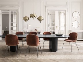 A pair of Randaccio circular wall mirrors in a vintage brass finish, and a trio of Multi-Lite Pendant lamps designed by Louis Weisdorf, add a brassy touch of bling to this room dominated by Celadon's Moon dining table, part of the Gubi collection.