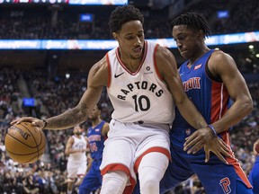 Toronto Raptors' DeMar DeRozan (left) shields the ball from Detroit Pistons' Stanley Johnson in Toronto on Monday, February 26, 2018. (THE CANADIAN PRESS/Chris Young)